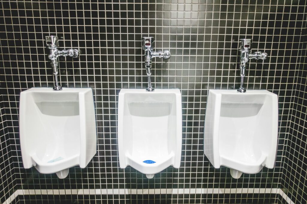 White Urinal on Back Tiles Wall