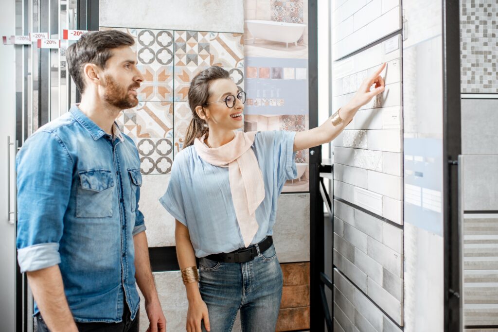 Couple choosing ceramic tiles in the shop