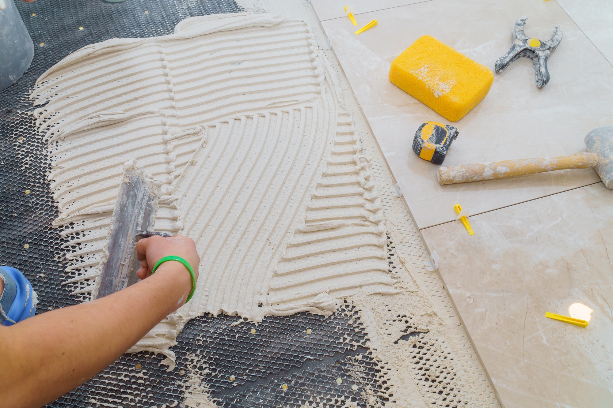 Floor tiles installation. Ceramic tiles and tools for home improvement, renovation